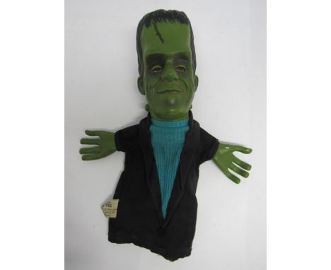 The Munsters- A 1964 Mattel Herman Munster talking glove puppet, lacking voice box and string, small hole in black coat