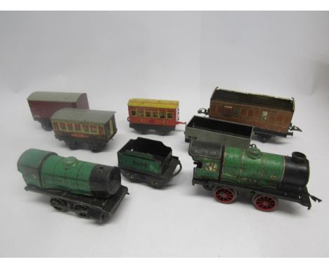Two playworn Hornby 0 gauge model railway tinplate clockwork 0-4-0 locomotives, one tender and five assorted playworn 0 gauge