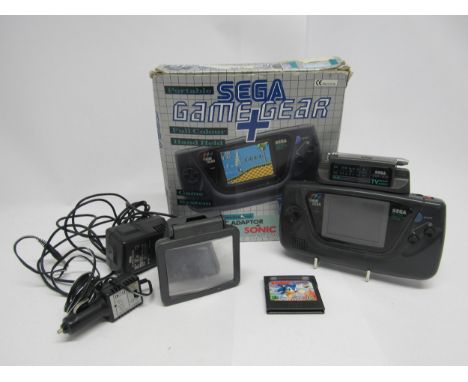 A Sega Game Gear handheld computer games console with original box (worn), together with TV Tuner attachment, mains adapter, 