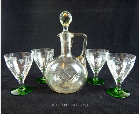 A set of four, 1950's hand-blown wine glasses with fluted bowls, green, circular bases and engraved floral decoration to each