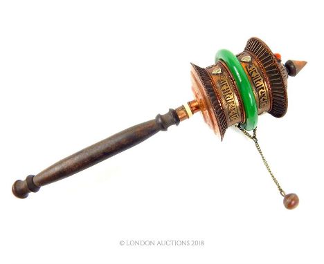 A 20th century Tibetan prayer wheel, copper with script and a band of jade coloured stone, 32 x 8 x 8cm.