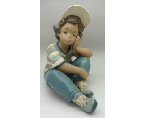 A Lladro figure, boy with cap, height 19.5cm