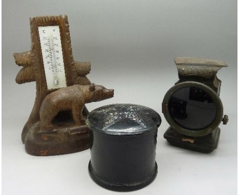 A carved Black Forest thermometer, a lacquered papier mache box with body brush and a Citadel cycle lamp