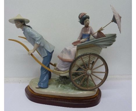 A Lladro figure, girl in rickshaw with parasol, on base, width 37cm
