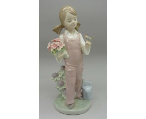A Lladro figure, Spring, girl with bird and flowers, 5217, height 18cm