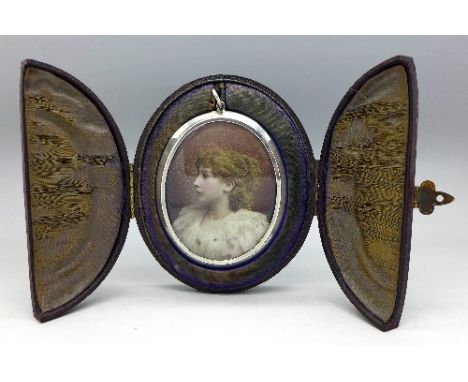 A large 19th Century white metal photograph locket, with portrait in fitted case