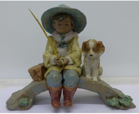 A Lladro figure, 2237, Old Fishing Hole, boy fishing with dog, width 29cm
