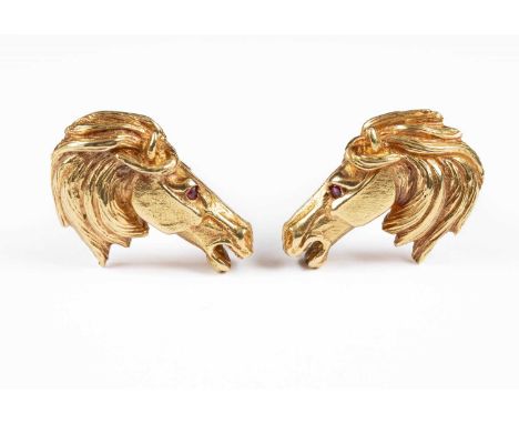  Equestrian interest: A pair of 18ct gold cufflinks cast as horse's heads, each with ruby eye, total gross weight approximate