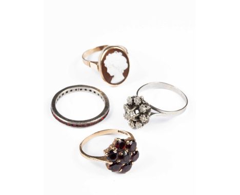 Four gold and silver dress rings, to include a 9ct gold and garnet cluster ring, size P½, approximately 3.7g, a cameo ring, s
