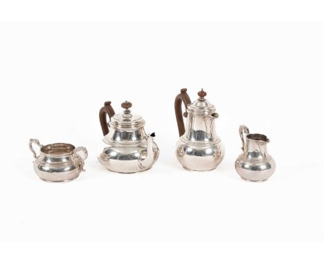 A four-piece silver tea set, Wakely &amp; Wheeler, London 1927, of circular form, comprising teapot, hot water jug, 19.5cm hi