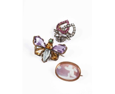 A Victorian diamond and ruby sweetheart brooch, having two intertwined hearts surmounted with a bow, silver settings on gold,