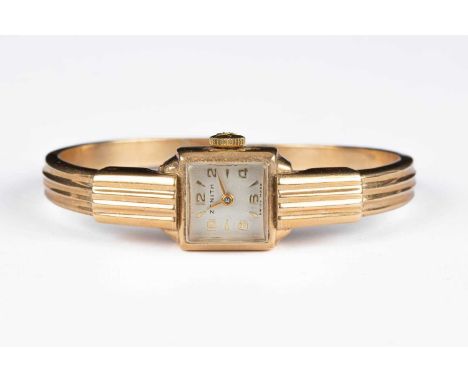A lady's 9ct gold Zenith wristwatch, the 10mm square dial with Arabic numerals and baton hour markers, sprung hinged bangle, 