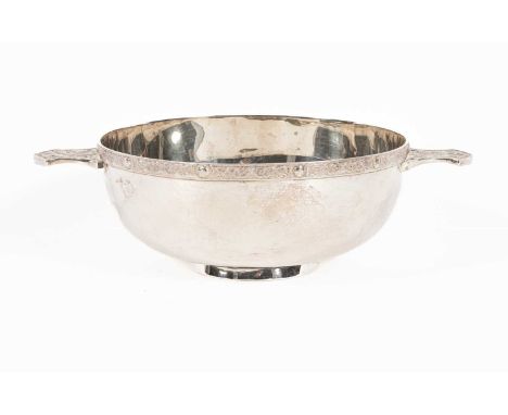 A silver quaich, Wakely &amp; Wheeler, London 1991, with Celtic designs to the handles and rim, 26cm across handles, approxim