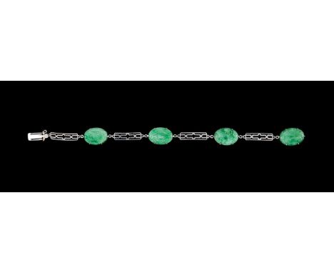 A 9ct white gold and jade bracelet, the four carved oval jade links joined by pierced rectangular links, approximately 8.5cm 