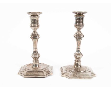 A pair of 18th Century style silver candlesticks, Hawksworth, Eyre &amp; Co., Sheffield 1887, weighted, 20cm highOne stick is