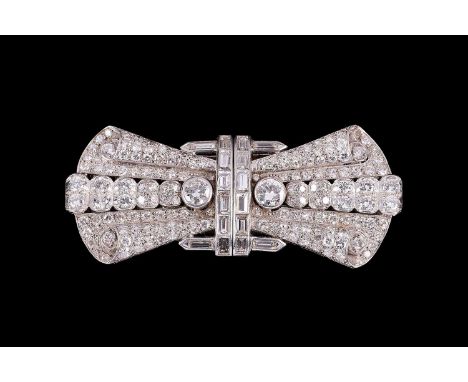 An Art Deco diamond set double-dress clip/brooch of bow form, each detachable clip set with baguette and round cut diamonds, 