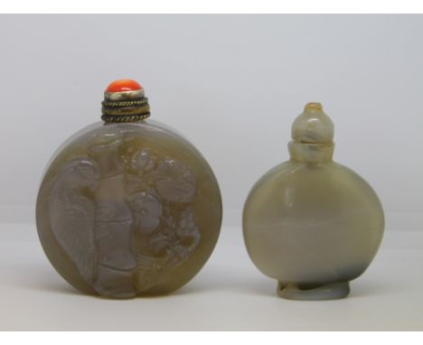 Two 20th century Chinese grey agate snuff bottles, one carved with a parrot, bamboo and flowers with red coral stopper, 6.5cm