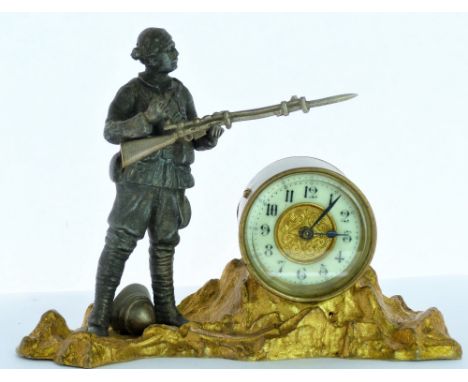 Early 20th century clock by British United Clock Co. in brass and spelter case with soldier and rifle c1900. 18cm long.   Con