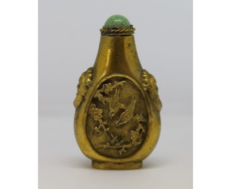 Late 19th /early 20th century Chinese gilt bronze snuff bottle, cast with birds on prunus boughs and lion masks, turquoise st