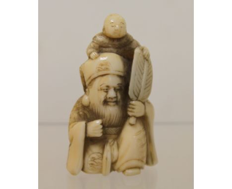 Japanese Meiji period carved bone netsuke of Jurojin with fan and small child, 5cm high.