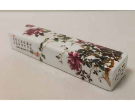 Chinese Republic famille rose porcelain rectangular scroll weight decorated with roses and poetic inscription, 20cm long.