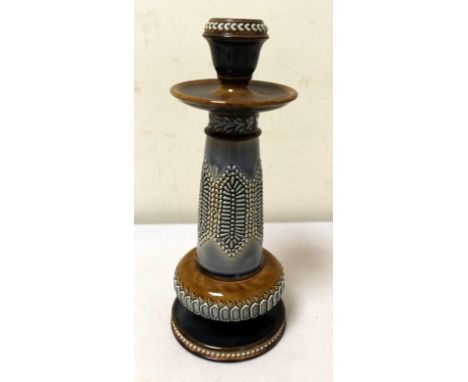 Doulton Lambeth stoneware candlestick with embossed panels and borders. Impressed mark, incised initials EM. 24cm high.  Cond