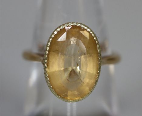 9ct gold dress ring set with an oval yellow stone.  Ring size M.  Approx weight 3.9 grams.(B.P. 21% + VAT) 