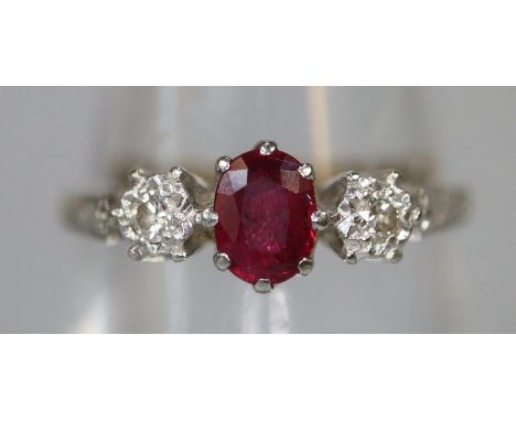 18ct gold ruby and diamond three stone ring. Ring size N. Approx weight 2.1 grams. (B.P. 21% + VAT)   Condition is good, no o