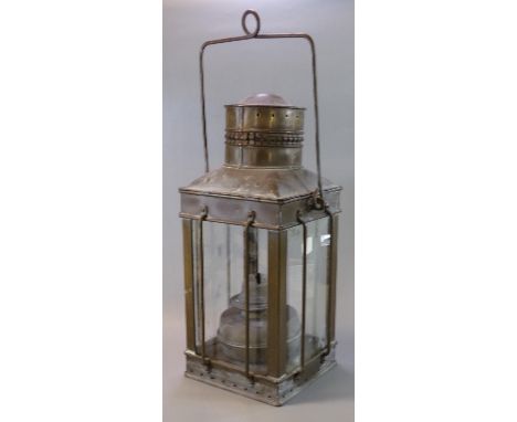 Early 20th Century copper and glass lantern with swing handle, the interior revealing a single oil burner reservoir. (B.P. 21