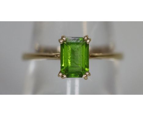 9ct gold dress ring set with a step cut green stone.(B.P. 21% + VAT) 