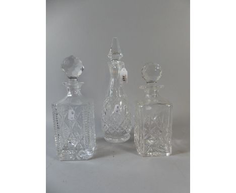 A Cut Glass Mallet Decanter and Two Spirit Decanters