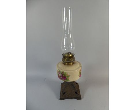 A Late Victorian Cast Iron Based Oil Lamp with Squirrel Decoration Having Ceramic Reservoir, 51cm High 
