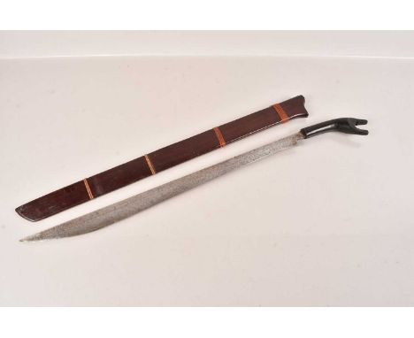 A Sumatran Machete, also known as a Sikin Panjang', with 52cm, single edged tapering blade, complete with wooden sheath, no p