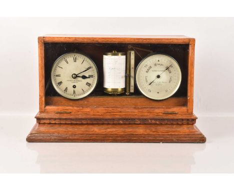 A Negretti &amp; Zambra Weather Station, complete with Clock and Barograph, having oak case with glazed drop down front, key 