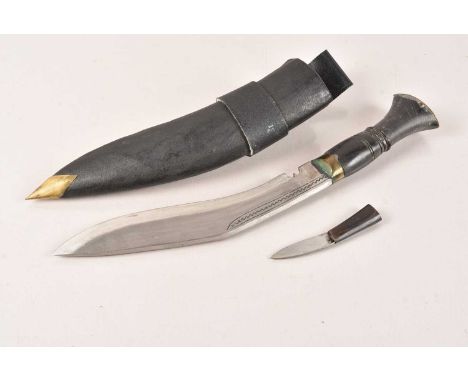 A Middle Eastern Kukri Knife, having horn handle with brass pommel, 22cm long single edged blade, wit engraved design, comple