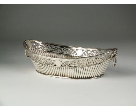 A Victorian silver bread basket, C F, Sheffield 1882, of navette form with reeded body and pierced scrolling rim, mounted wit