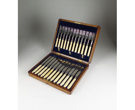 A cased set of twenty-four Edwardian silver knives and forks, Levesley Brothers, Sheffield 1908, comprising twelve knives and