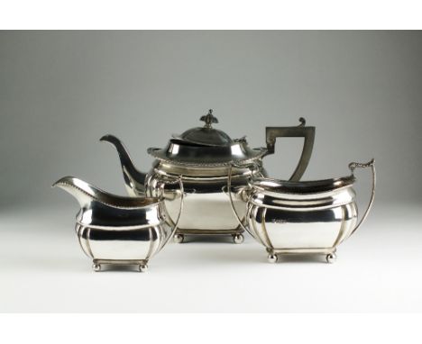 An Edwardian three piece silver tea service, James Deakin & Sons, Sheffield 1904, each piece of shaped rectangular form with 