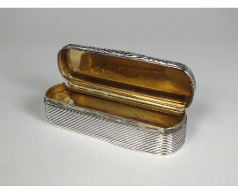 A William IV silver snuff box, Edward Smith, Birmingham 1830, of elongated oval reeded form, scroll thumbpiece and silver gil