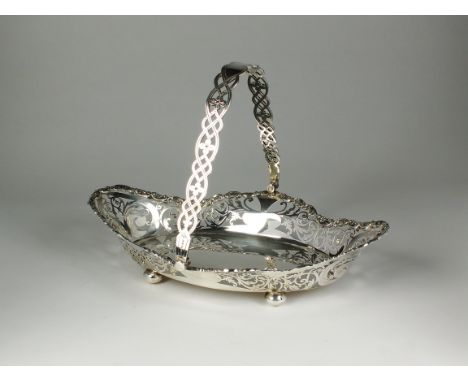 A George V silver swing handled basket, William Hutton &amp; Sons Ltd, Sheffield 1913, of oval form with decorative pieced si