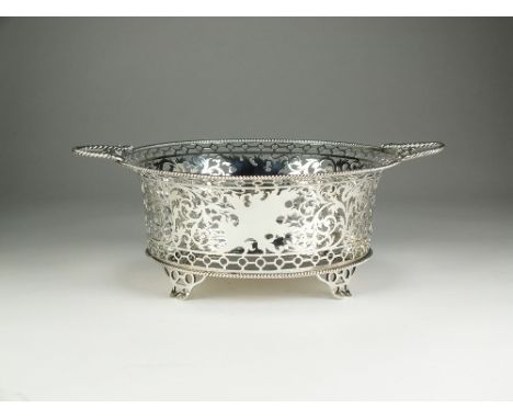 An Edwardian Scottish silver pierced basket, James Aitchison, Edinburgh 1909, of circular form with scrolled decoration and t