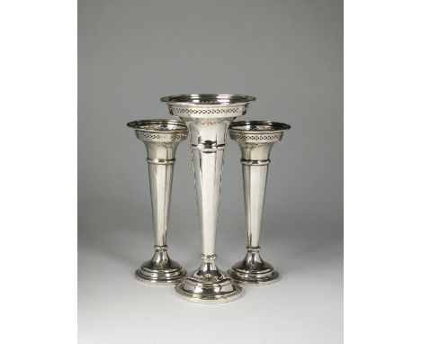 A garniture of three silver mounted posy vases, Walker & Hall, Sheffield 1925 & 1926, each of trumpet form with pierced rim a