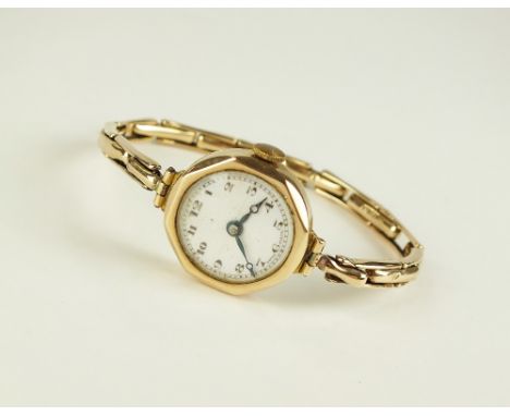 A Lady's 9ct gold Swiss made wristwatch, the octagonal case housing white enamel circular dial with Arabic numerals, manual w