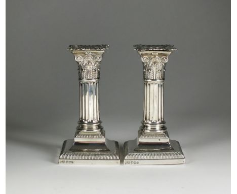 A pair of silver mounted short candlesticks, Hawksworth, Eyre & Co Ltd, Sheffield 1920, each designed as a Corinthian column 