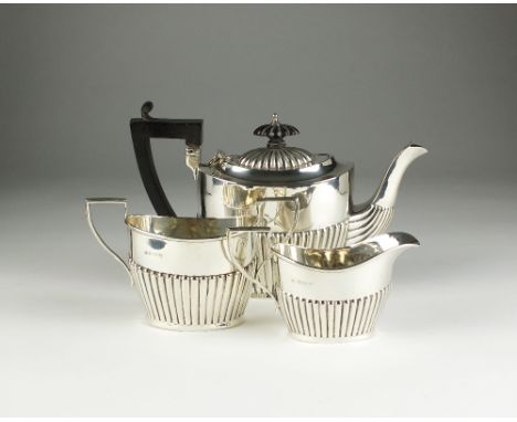 A three piece silver tea service, Isadore Leapman, Birmingham 1911, each piece of oval half reeded form, comprising; a teapot