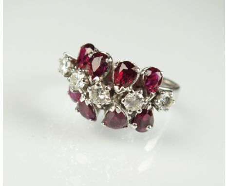A diamond and ruby dress ring, designed as a central row of five brilliant cut diamonds, flanked to each side by a row of fou