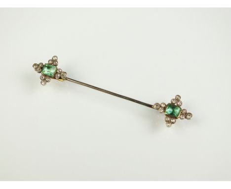 An emerald and diamond stick pin, designed as two clusters each set with central rectangular faceted emerald within four diam