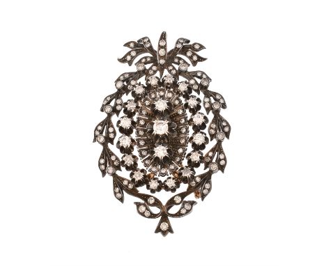 A diamond brooch pendant, central oval panel set with brilliant cut and eight cut diamonds, within an surround of claw set di