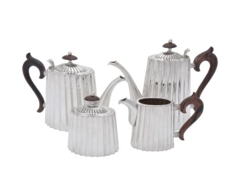 An Italian silver coloured oval fluted four piece tea set, Milano post 1968 .925 standard, the tea pot with a wooden oval fin