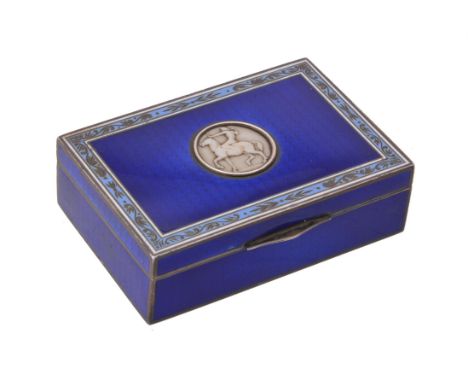 Y A silver, blue enamelled and ivory mounted box, circa 1922, indistinct marks, with blue guilloche enamel, a foliate border,